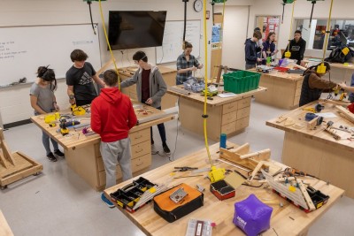 Students work in the shop on mechanisms.